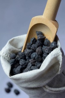 Black chickpeas in sack and wooden shovel