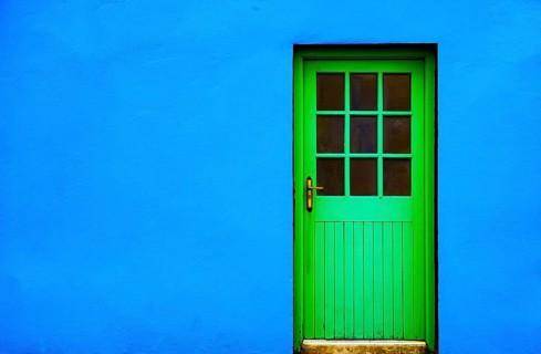 Blue house facade with green front door