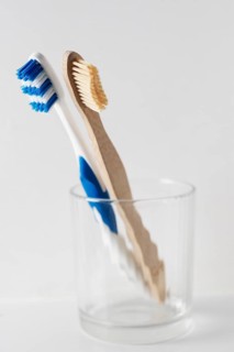 Wooden and plastic toothbrush in glabecher. Switzerland