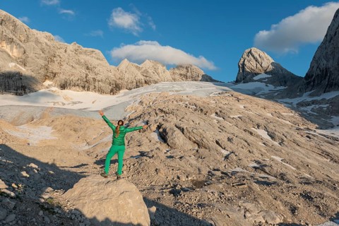 Hiker stretches arms in the air