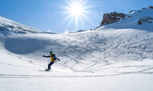 Snowboarder with splitboard rides in the snow