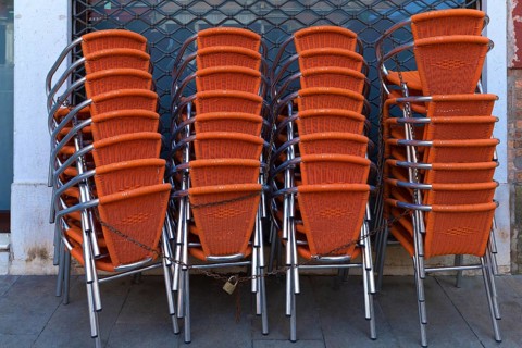 Locked stacking chairs in front of a restaurant