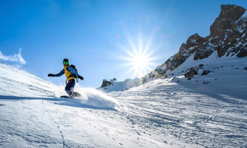 Snowboarder with splitboard rides in the snow