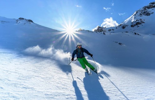 Skier with touring skis skiing in the snow