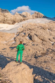 Hiker looks at alpine landscape