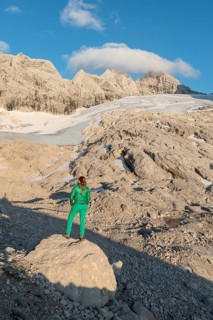 Hiker looks at alpine landscape