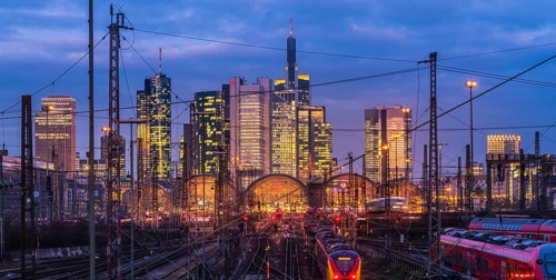 Train and tracks in front of main station and skyline Frankfurt Main in the evening