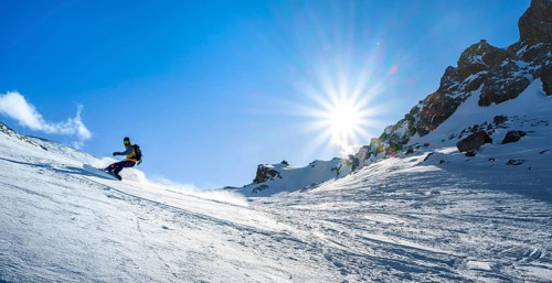 Snowboarder with splitboard rides in the snow