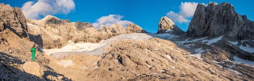 Hiker looks at alpine landscape