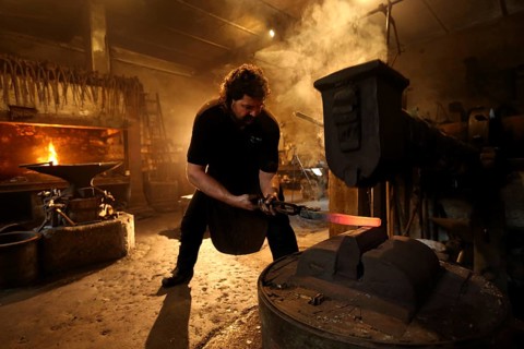 Blacksmith at the forge hammer