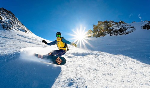 Snowboarder with splitboard rides in the snow