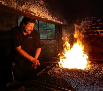 Blacksmith at the blacksmith's hearth