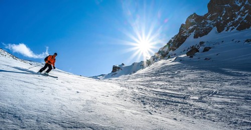 Skier with touring skis skiing in the snow