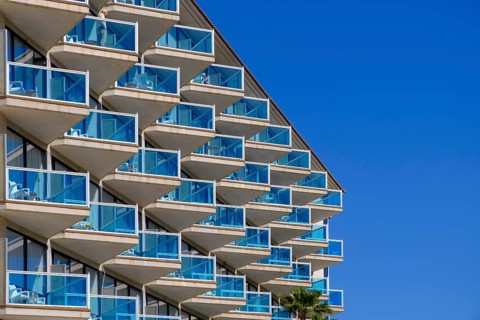 Balconies with blue glass railings at Hotel Cactus