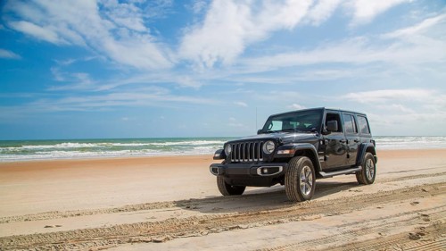 Jeep Wrangler drives over beach
