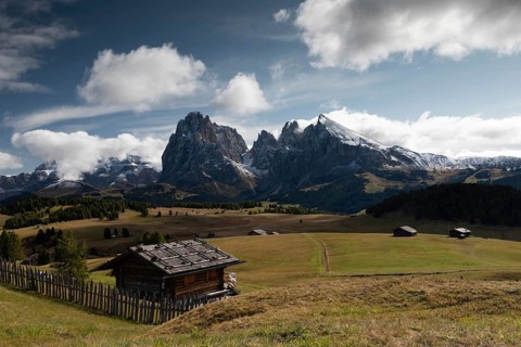 Hut in front of mountain range