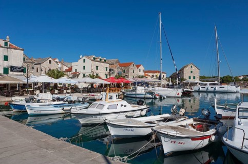 Promenade with fishing boats in the port