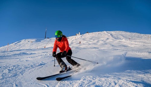 Skier descending a steep slope