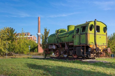 Old locomotive and factory buildings