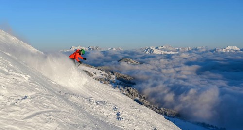 Female skier descending steep slope