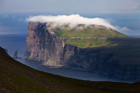 Landscape overlooking the northeast coast of Eysturoy in the North Atlantic with the stone columns Risin og Kellingin