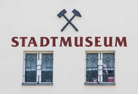 Inscription city museum with symbol mallet and iron
