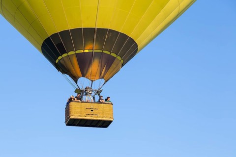 Basket of a hot-air balloon with people