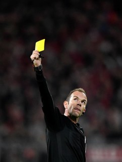 Referee Marco Fritz shows yellow card