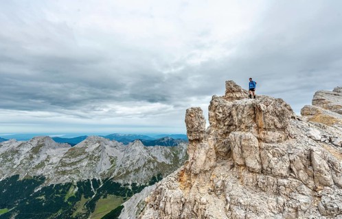 Mountaineer stands on a rock