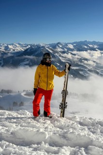 Skier standing at the ski slope holding ski