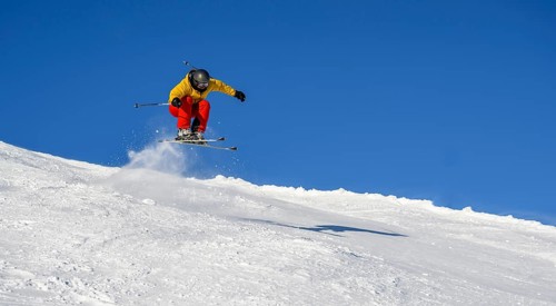 Skiers jumping on the ski slope