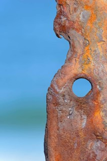 Old rusty sheet pile wall element with hole