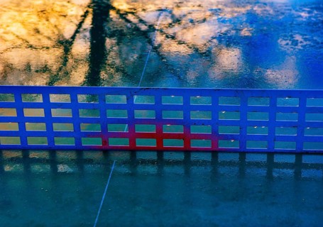 Reflection on a rain-wet table tennis table
