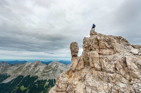Mountaineer stands on a rock