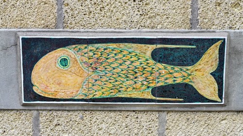 Pottery with fish motif on a house wall