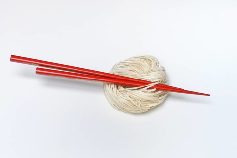 Asian nest noodles with red chopsticks