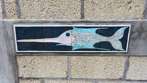 Pottery with fish motif on a house wall
