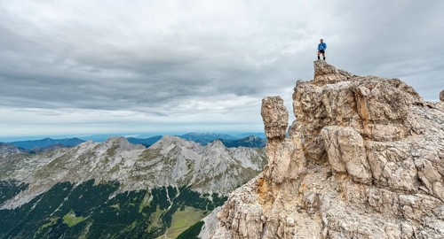 Mountaineer stands on a rock