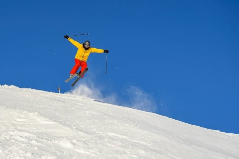 Skiers jumping on the ski slope