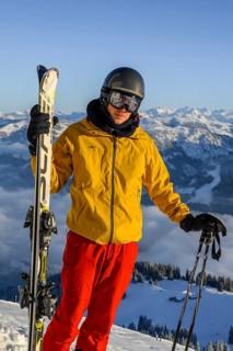 Skier standing at the ski slope holding ski
