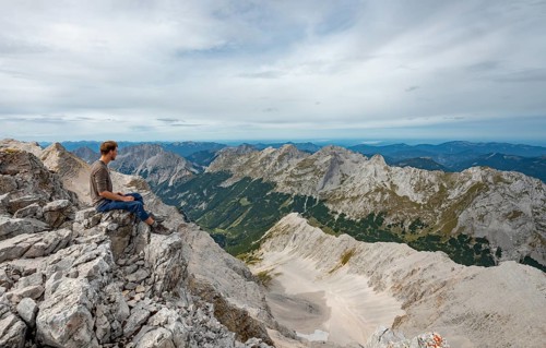 Hiker sitting at the summit of the Birkkarspitze