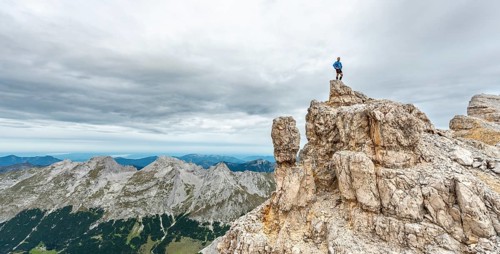 Mountaineer stands on a rock
