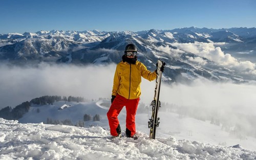 Skier standing at the ski slope holding ski