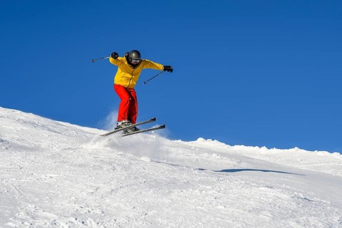 Skiers jumping on the ski slope