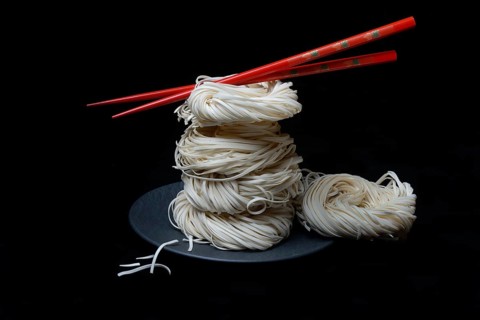 Asian nest noodles with red chopsticks