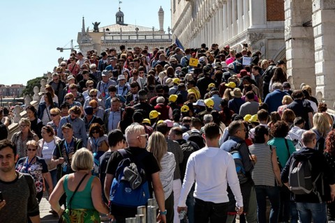 Tourists on the Ponte de Paglia visit the Bridge of Sighs