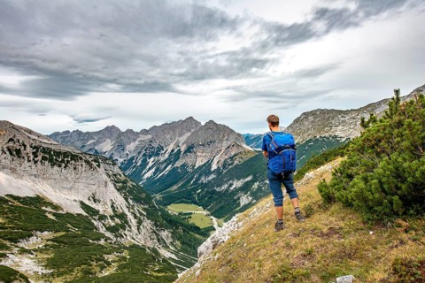 Hiker looks into the Karwendel valley with Raffelspitze and Hochkarspitze
