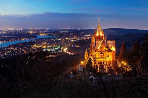 Illuminated Drachenburg Castle above the Rhine Valley in the evening
