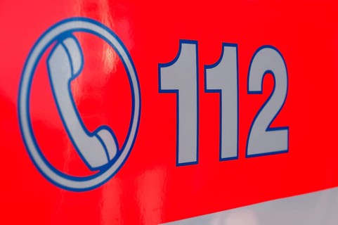 Inscription of the emergency number 112 on a rescue vehicle