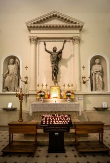 Side altar with burning sacrificial candles